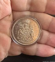 Reverse of 1966 Canadian 50-cent coin in holder
