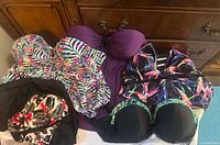 Overview of five tankini tops and halter dress laid out