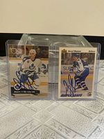 Both autographed Darryl Shannon cards in top loaders