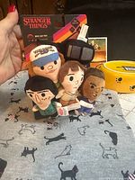 All items grouped: T-shirt, toys, bowl, card