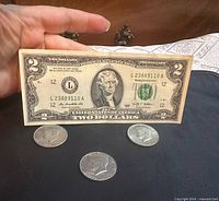 Front of 2009 $2 bill with three Kennedy halves