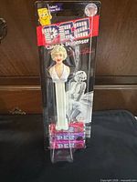 Front view of sealed Marilyn Monroe PEZ dispenser showing dispenser and candy packs