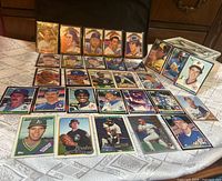 Full spread of assorted baseball cards on table
