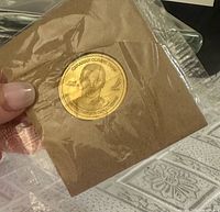 Coin in plastic sleeve showing bust of Steve Yzerman