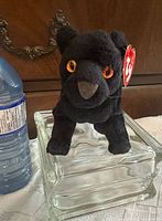 Front view of black panther Beanie Baby Midnight with tags and orange eyes