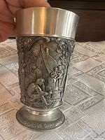 Goblet side view showing raised relief village scene