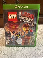Front of sealed green Xbox One case showing cover art and rating