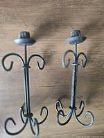Pair of black wrought iron scroll candle holders full view