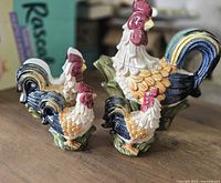 Front view of ceramic rooster teapot, two matching shakers and napkin holder