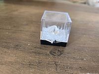 Fluorite specimen in clear acrylic display box, angled view