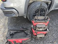 Overview of both Husky bags beside vehicle tire