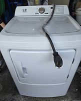 Front view of white L2 electric dryer with power cord draped over top