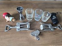 All nine bar and beverage accessories laid out on tabletop