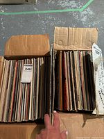 Two open boxes filled with upright vinyl LPs