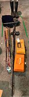 group view of rods, tackle boxes, reel, net, boots and line spool
