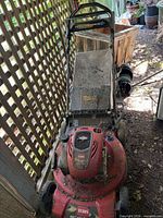 Full view of Toro self-propelled mower showing handle, deck, overall condition