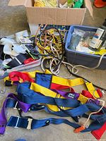 Overview of lot: harnesses, ropes, spools in boxes