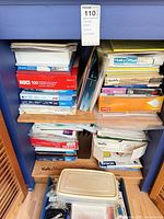 Shelved assortment of printer paper reams, label boxes and photo paper