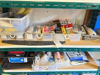 Shelving with paint tray, roller frames, roller covers, sanding block, sandpaper, small tools