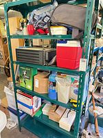 Full shelf view showing all items including cooler, cylinder, boxes
