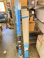 Packaged Coolaroo roller shade tube and boxed For Living blinds standing upright