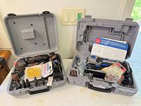 Both open Dremel cases showing Contour Sander, Trio tool and accessories