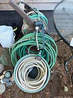 Full view of both hoses, reel, spray nozzle and sprinkler