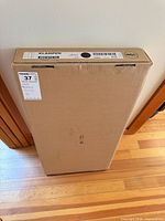 Sealed IKEA KLAMPEN cabinet box showing product label and size