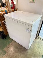 Front and top view of white Kenmore chest freezer showing overall form and control label
