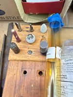 Rotary burrs in wooden stand with blue tube and wood surface