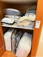 Closet shelf showing duvets and comforters in plastic