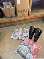 Packaged storage hooks, tool hanger set, black triangular brackets on floor