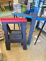 Mastercraft plastic sawhorse, blue crossbeam and folded metal legs