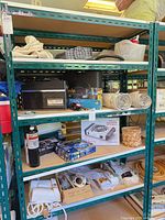 Full view of green steel shelving unit with contents