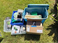 Assorted bins and box containing irrigation parts, hoses, timers, fittings