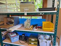 Shelving view showing sander, accessories and box in storage