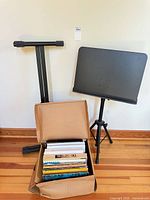 Overall lot showing both stands and open box of sheet music