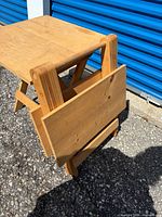close view of one table folded to display collapsible feature
