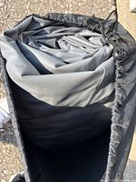 Rolled grey air mattress inside carry bag