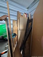 View of stacked plywood, boards and panels inside locker