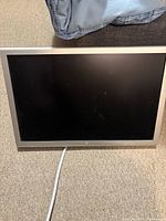 Front view of Apple Cinema Display LCD monitor, black screen and aluminum bezel