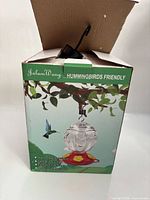 Box showing JalamWang hummingbird feeder with hook inside