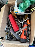 Overview of cardboard box with tools and hardware