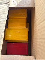 Cardboard carton with multiple yellow and red MTM boxes visible