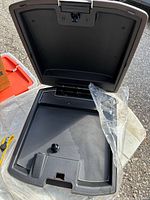 Open console lid showing black interior tray and latch