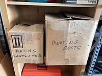 Two cardboard boxes labelled Hunting Gloves & Mitts and Hunting Boots