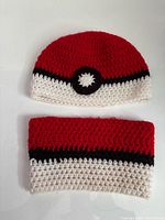 Beanie and matching scarf laid flat showing color scheme and crochet detail