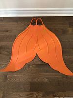 Full view of orange Mahina monofin showing complete shape