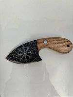 Knife showing etched snowflake blade and wood handle