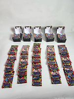 Eight opened display boxes in rear row; four columns of sealed booster packs laid out front